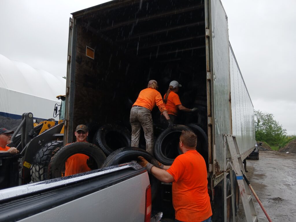 Volunteers loading tires into truck